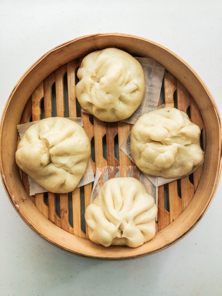 Steamed char siu bao in bamboo steamer