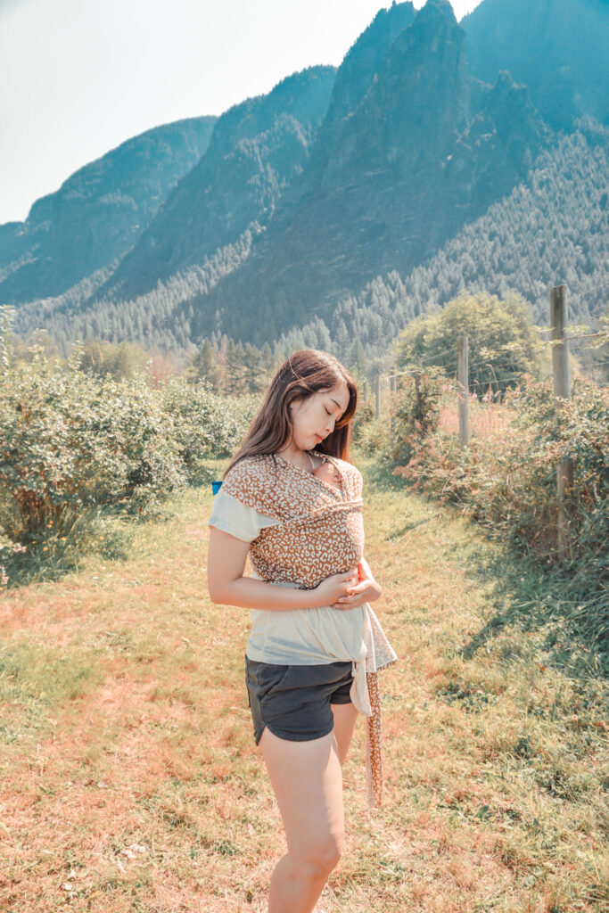 Mom wearing solly baby wrap in leopard print by Mt. Si.
