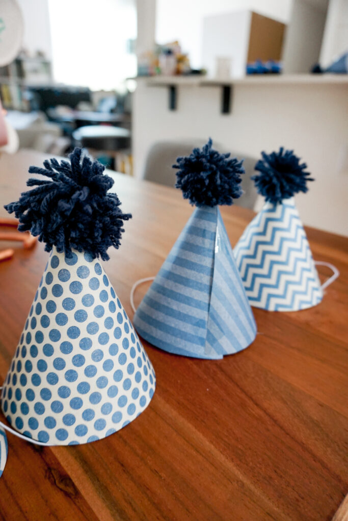 DIY party hats with DIY pom poms