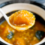 closeup of ladle holding kabocha