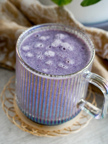 purple sweet potato latte in a clear glass cup