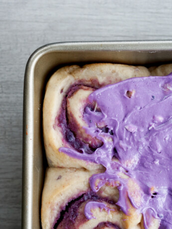purple sweet potato cinnamon rolls semifrosted overhead view