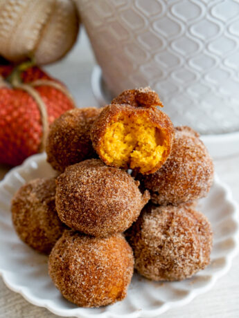pumpkin mochi donuts closeup with a bite taken out the top donut