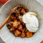 overhead shot of persimmon crisp in a Japanese ceramic bowl with vanilla ice cream