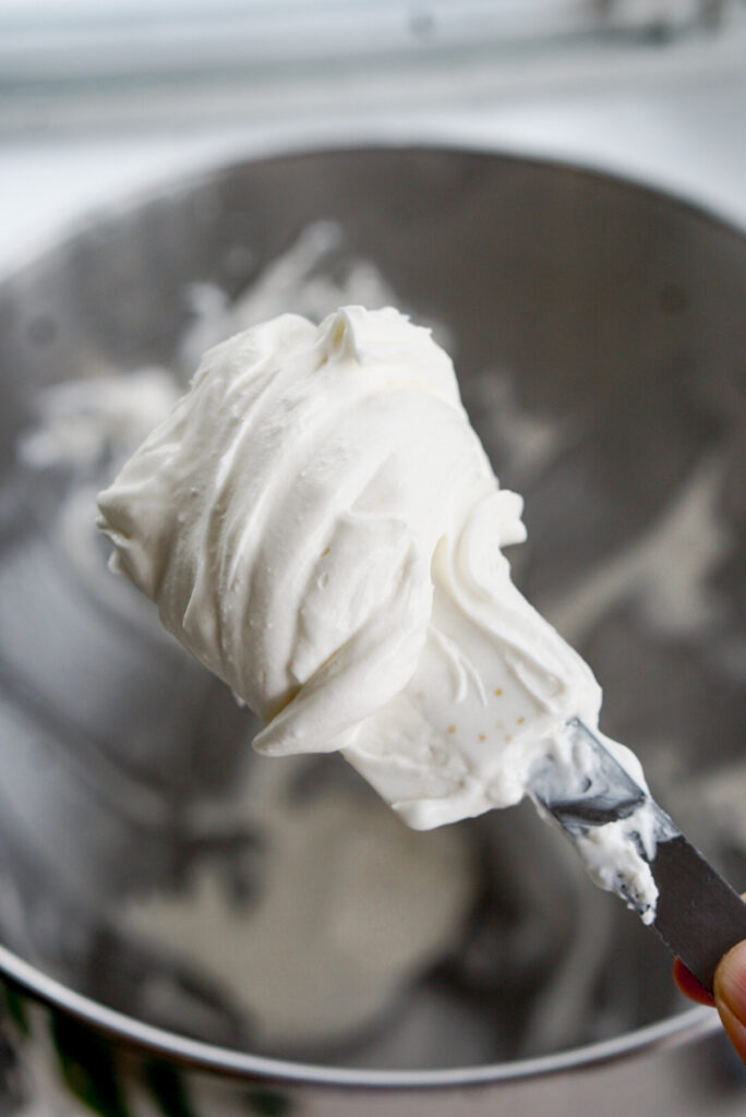whipped cream cream cheese frosting on a rubber spatula