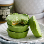 matcha white chocolate pistachio butter cups stack of three with one leaning on the side