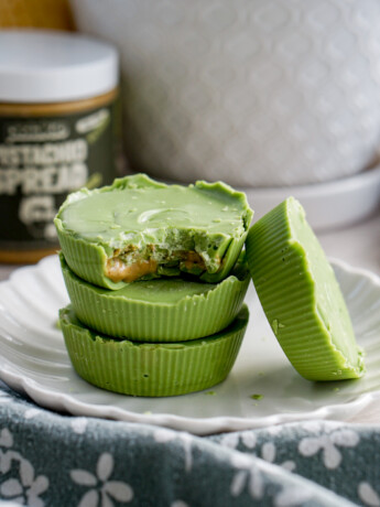 matcha white chocolate pistachio butter cups stack of three with one leaning on the side