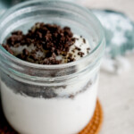 melo melo coconut jelly dessert copycat recipe in a glass jar with oreo crumbs on top