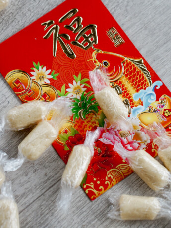 wrapped white milk candies on top of chinese new year red envelope